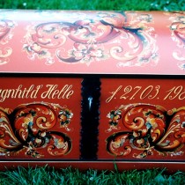 Large red chest with rosemaling decorations