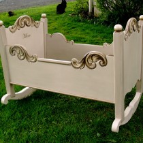 Restored white cradle with rosemaling decorations